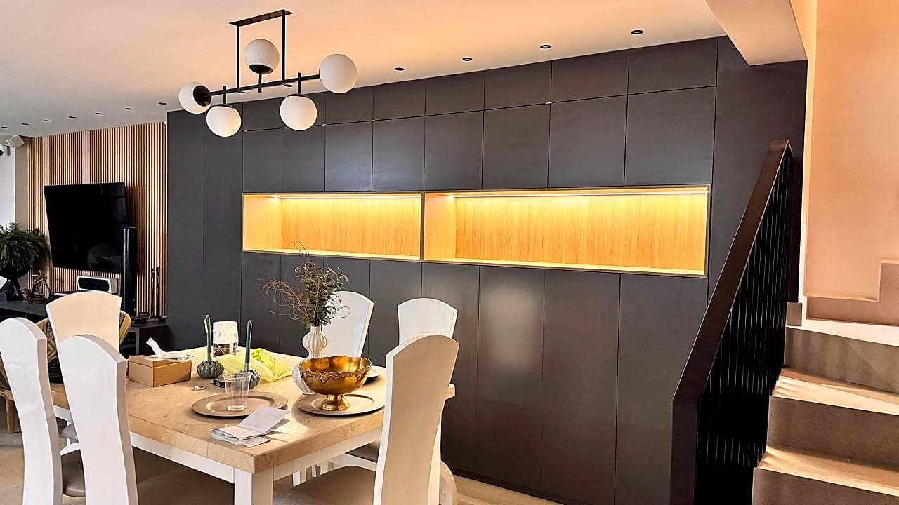 Dining room with custom millwork and warm lighting in Bucaramanga