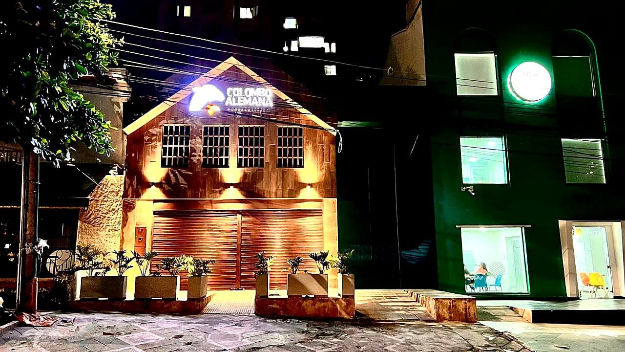 Night-time timber façade of the Colombo Alemana shop in Bucaramanga