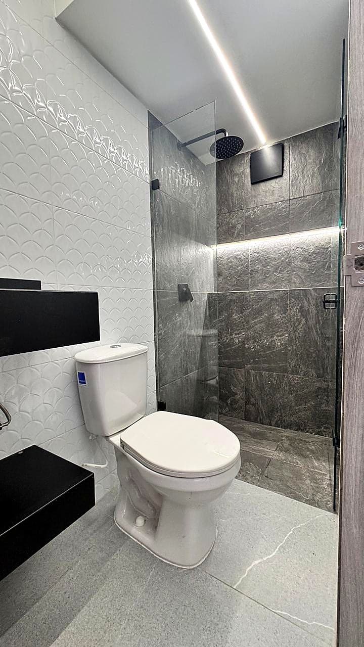 Bathroom with grey porcelain shower and glass screen